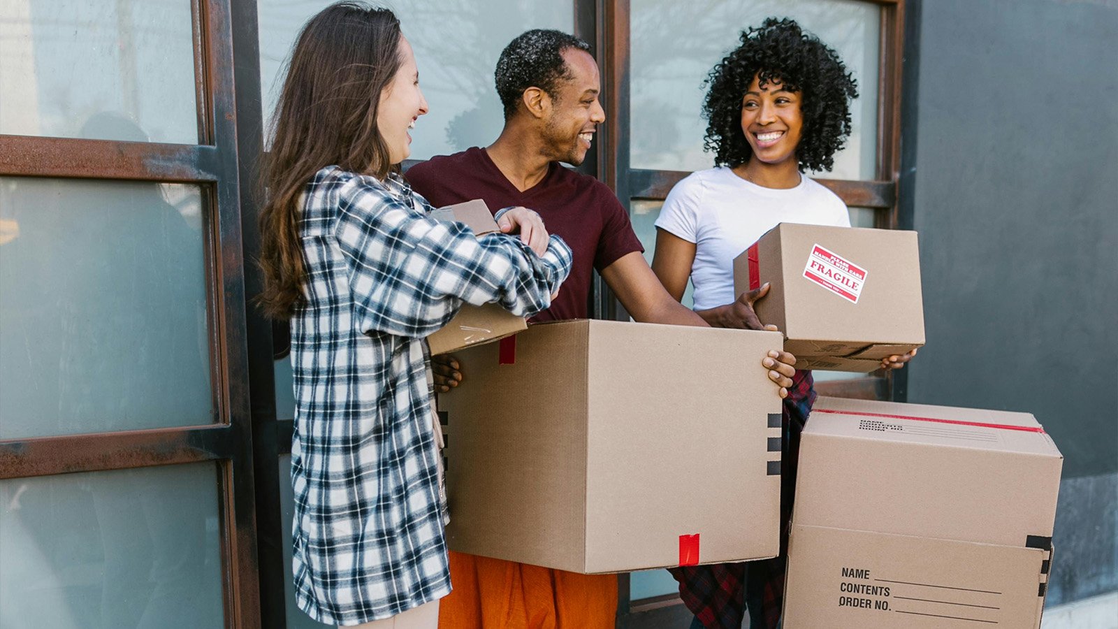 Group of friends moving into their new home purchased with a HomeShare Mortgage 