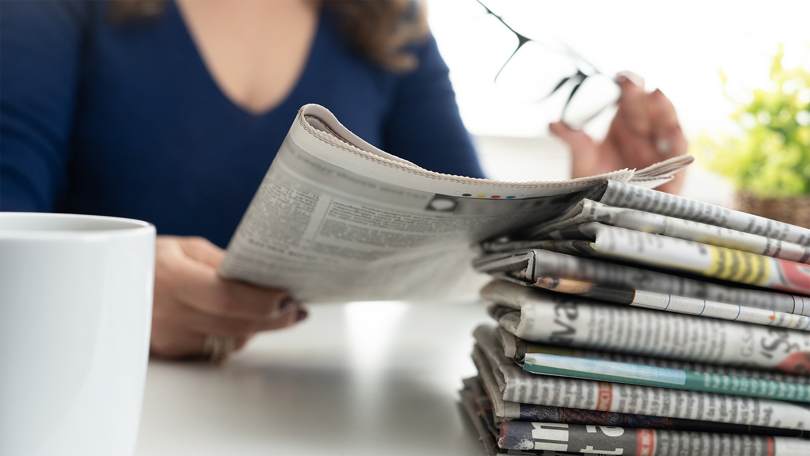 The Most Read Stories of 2025 - Woman reading newspaper 