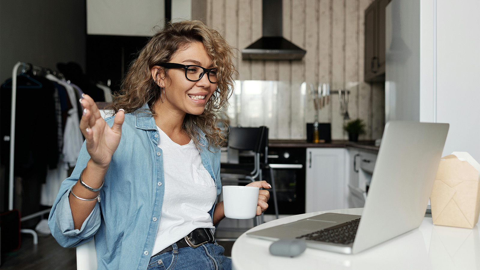 Young woman reacting to an interaction on her laptop 