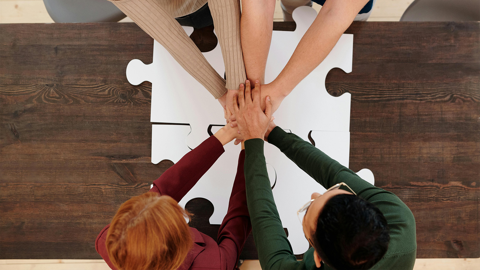 A circle of friends clasping hands
