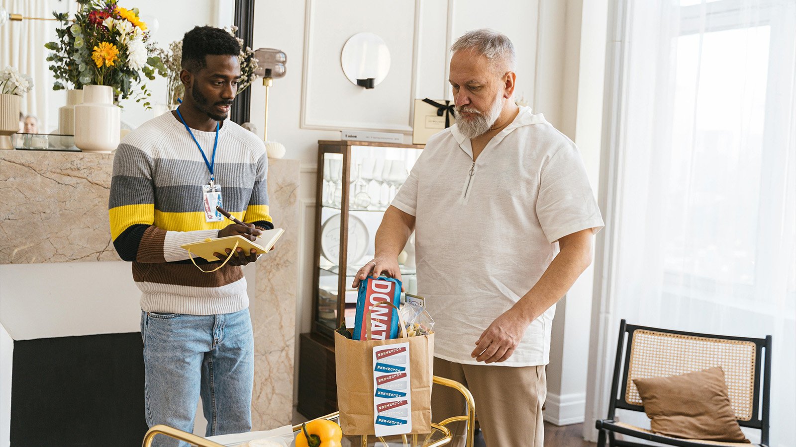 Two men sorting through donated food