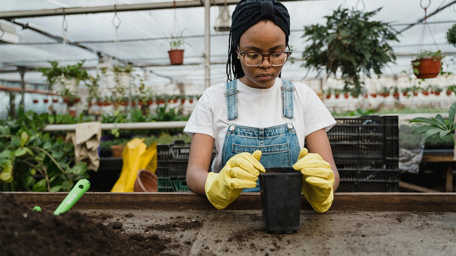 Young woman planting at a community garden